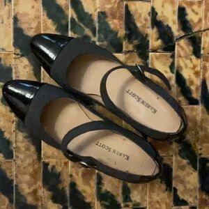 These Karen Scott heels are a size six. They are dark grey with a black tip